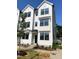 White new construction townhome featuring modern design and landscaping at 3113 White Blossom Ct, Raleigh, NC 27610