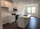 Bright kitchen with white cabinets, stainless steel appliances, and large island at 3113 White Blossom Ct, Raleigh, NC 27610