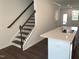 Bright kitchen area with island and staircase featuring modern design elements at 3113 White Blossom Ct, Raleigh, NC 27610