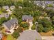 Aerial view showcasing a beautiful home with mature trees in a well-landscaped neighborhood at 315 Birdwood Ct, Cary, NC 27519