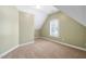 This room has green-beige walls, beige carpet, one window, and sloped walls at 315 Birdwood Ct, Cary, NC 27519