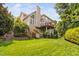 Landscaped backyard with a deck and stairs, providing an outdoor space for relaxation and entertainment at 315 Birdwood Ct, Cary, NC 27519