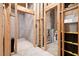 Partially finished basement with framed walls, storage shelves, and concrete flooring at 315 Birdwood Ct, Cary, NC 27519