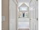 This open bathroom features a large window, a tub, a large vanity, and white floors at 315 Birdwood Ct, Cary, NC 27519