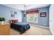 Comfortable bedroom with blue walls, a window, a ceiling fan, and carpeted floors at 315 Birdwood Ct, Cary, NC 27519