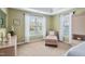 This bedroom features neutral colored walls, white trim, and a window with white curtains at 315 Birdwood Ct, Cary, NC 27519