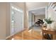 Inviting foyer with hardwood floors, a grand entrance door, and a glimpse into the piano room at 315 Birdwood Ct, Cary, NC 27519