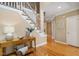 Bright foyer with hardwood floors, a staircase, and a stylish console table adding a touch of elegance at 315 Birdwood Ct, Cary, NC 27519