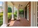 Spacious front porch with brick flooring, white columns, and manicured landscaping offering great curb appeal at 315 Birdwood Ct, Cary, NC 27519