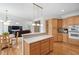 Kitchen island with wood cabinets with stone countertops and pendant lighting at 315 Birdwood Ct, Cary, NC 27519