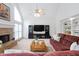 Open-concept living room with fireplace and large windows at 315 Birdwood Ct, Cary, NC 27519