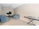 Cozy living room featuring comfortable blue sofas, a TV, and a keyboard at 315 Birdwood Ct, Cary, NC 27519