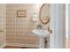 Charming powder room with hardwood floors, pedestal sink, and decorative wallpaper at 315 Birdwood Ct, Cary, NC 27519