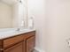 Bathroom featuring a single sink, wood cabinets, mirror, and neutral walls at 3825 Cary Glen Blvd, Cary, NC 27519