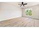 Bedroom with wood-look floors, a ceiling fan, and a window at 3825 Cary Glen Blvd, Cary, NC 27519