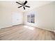 Bedroom featuring hardwood floors, ceiling fan, window, and closet at 3825 Cary Glen Blvd, Cary, NC 27519