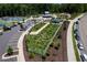 Aerial view of the fenced community garden with parking and sidewalks at 3825 Cary Glen Blvd, Cary, NC 27519
