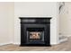 Living area featuring a fireplace with black mantle and hardwood floors, adding warmth and style to the home at 3825 Cary Glen Blvd, Cary, NC 27519