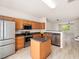 Bright, open-concept kitchen with island, stainless steel appliances, and laminate floors at 3825 Cary Glen Blvd, Cary, NC 27519