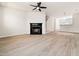 Spacious open-concept living room with fireplace, light laminate flooring and plenty of space at 3825 Cary Glen Blvd, Cary, NC 27519