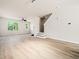 Bright and spacious living room with laminate floors and staircase leading to upper level at 3825 Cary Glen Blvd, Cary, NC 27519