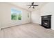 Inviting living room with fireplace, light laminate flooring and ample natural light from large windows at 3825 Cary Glen Blvd, Cary, NC 27519