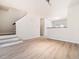 Bright and spacious living room featuring hardwood floors and stairs that lead to the upper level at 3825 Cary Glen Blvd, Cary, NC 27519