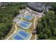 Aerial view of the community tennis courts surrounded by lush trees at 3825 Cary Glen Blvd, Cary, NC 27519