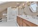 Well-lit bathroom featuring a double vanity, and a tiled shower at 406 E Whitaker Mill Rd, Raleigh, NC 27608