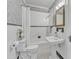 Classic bathroom features white fixtures, black and white tile, and patterned wallpaper at 406 E Whitaker Mill Rd, Raleigh, NC 27608