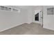 Bright bedroom with neutral carpet and an attached storage room at 406 E Whitaker Mill Rd, Raleigh, NC 27608