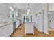 Bright kitchen featuring white cabinets, center island, and stainless-steel appliances at 406 E Whitaker Mill Rd, Raleigh, NC 27608