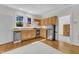 Bright kitchen with light wood cabinets, stainless steel appliances, and hardwood floors at 406 E Whitaker Mill Rd, Raleigh, NC 27608