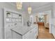 Modern kitchen with center island, white cabinets, and an open view to the living room at 406 E Whitaker Mill Rd, Raleigh, NC 27608
