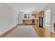 Bright kitchen with light wood cabinets, stainless steel appliances, and hardwood floors at 406 E Whitaker Mill Rd, Raleigh, NC 27608