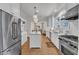 Well-lit kitchen with stainless steel appliances and center island overlooking living room at 406 E Whitaker Mill Rd, Raleigh, NC 27608