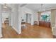 Bright living room showcasing hardwood floors, large window, and elegant chandelier at 406 E Whitaker Mill Rd, Raleigh, NC 27608