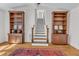Living room with hardwood floors, built-in shelving, and a decorative rug at 406 E Whitaker Mill Rd, Raleigh, NC 27608