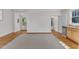Inviting living area with hardwood flooring, natural light, and adjacent kitchenette for effortless entertaining at 406 E Whitaker Mill Rd, Raleigh, NC 27608