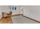 Bright living room with hardwood floors, a cozy dining area, and natural light from the window at 406 E Whitaker Mill Rd, Raleigh, NC 27608