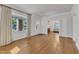Bright living room with hardwood floors and large windows, creating a warm and inviting atmosphere at 406 E Whitaker Mill Rd, Raleigh, NC 27608