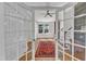Inviting living room with hardwood floors, red rug, and white french doors at 406 E Whitaker Mill Rd, Raleigh, NC 27608