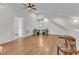 Upstairs bonus room features wood floors, vaulted ceiling, cozy chairs and natural light at 406 E Whitaker Mill Rd, Raleigh, NC 27608