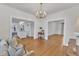 Spacious living room with hardwood floors and large open doorway to the kitchen at 406 E Whitaker Mill Rd, Raleigh, NC 27608