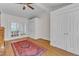 Open living area featuring hardwood floors, ceiling fan, and stylish french doors at 406 E Whitaker Mill Rd, Raleigh, NC 27608