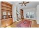 Spacious living room with hardwood floors, built-in shelving, and french doors at 406 E Whitaker Mill Rd, Raleigh, NC 27608