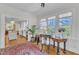 Home office with natural light from large windows and view of the all-white kitchen at 406 E Whitaker Mill Rd, Raleigh, NC 27608