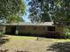 The backyard features a small deck and mature trees, creating a peaceful and private outdoor space at 417 Sunnyview Rd, Henderson, NC 27536