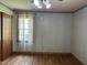 Bedroom featuring hardwood floors, a window with blinds and ample space for relaxation at 417 Sunnyview Rd, Henderson, NC 27536