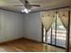 A bedroom with hardwood floors, neutral walls, and a sliding glass door to the deck at 417 Sunnyview Rd, Henderson, NC 27536